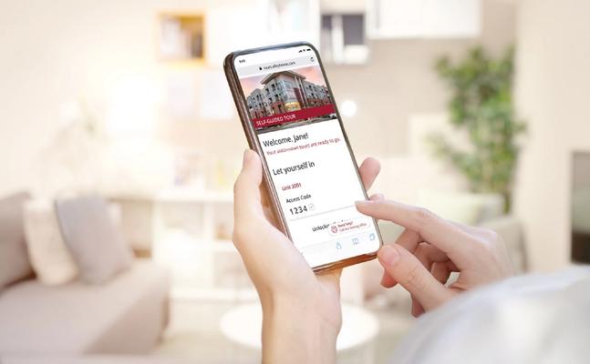 person holding phone with customized branding that available for communities using SmartRent's self-guided tours product