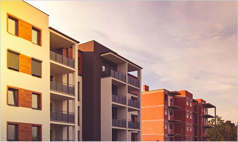 mid-rise apartment buildings at sunset