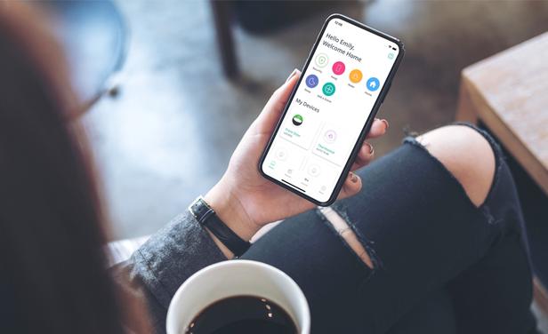 Woman holding phone with SmartRent mobile app visible