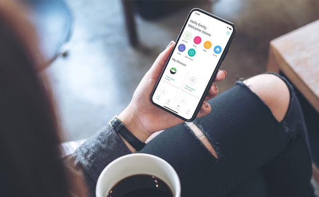 Woman holding phone with SmartRent mobile app visible