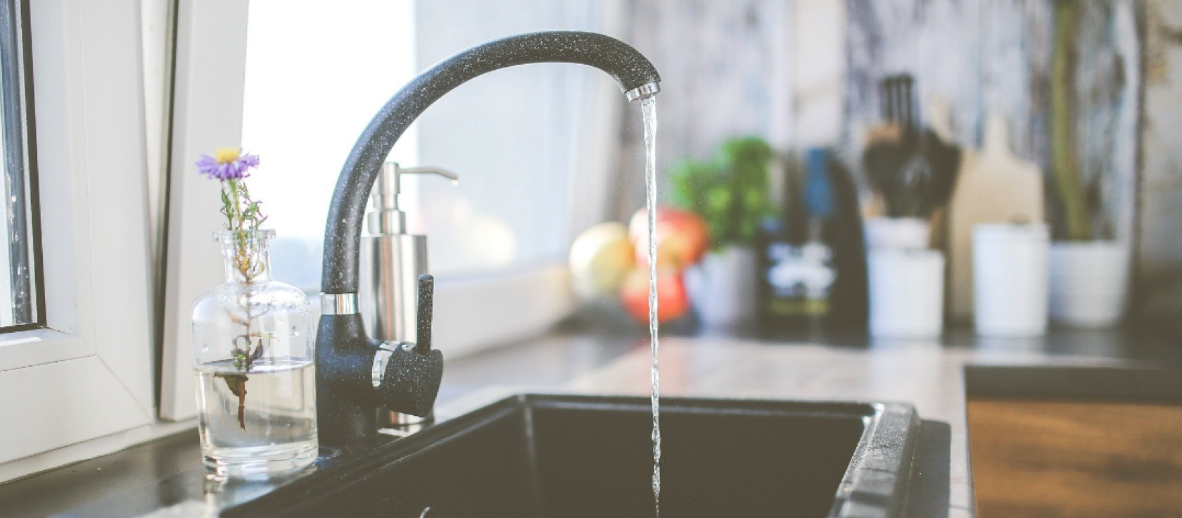 Image of a kitchen faucet with running water