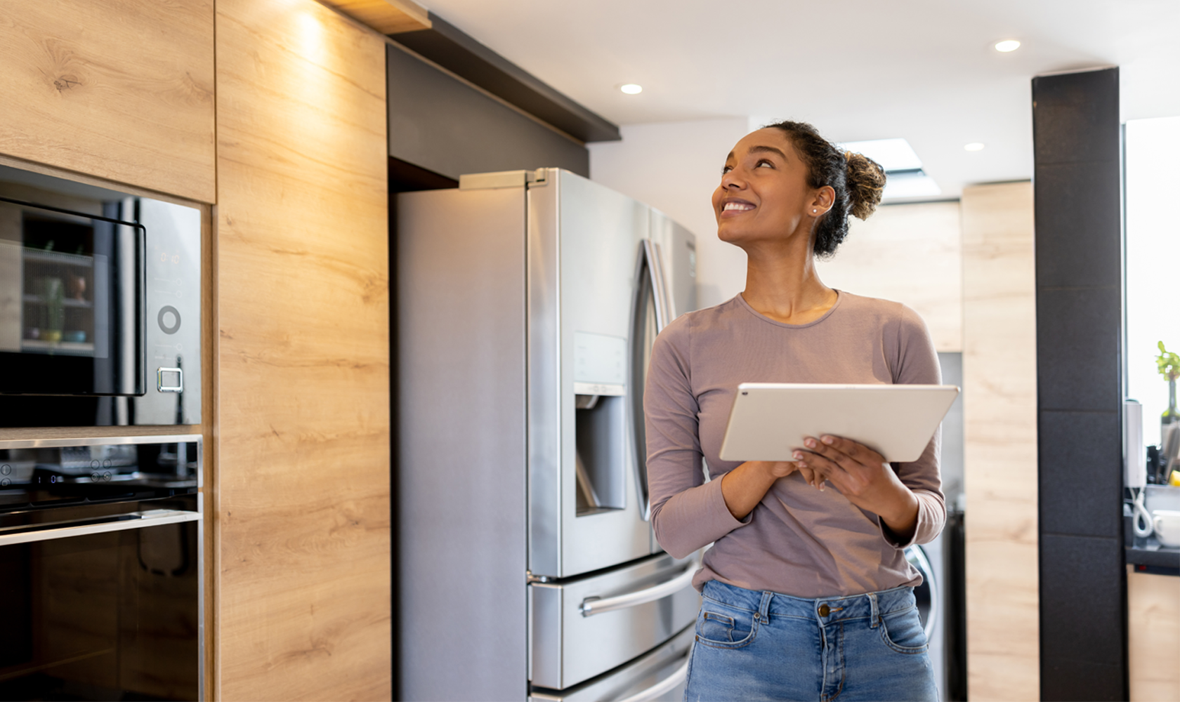 Young adult operates a smart home using a tablet. 