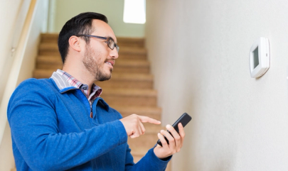 Resident uses smartphone to control a thermostat. 